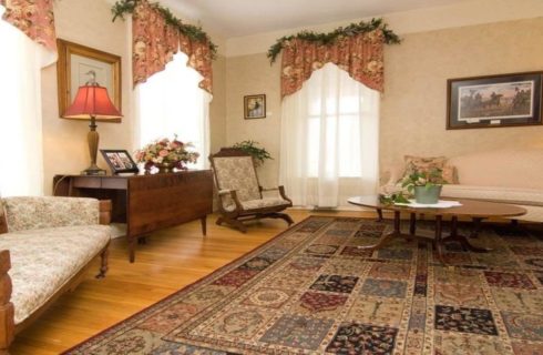 Elegant sitting room with two couches, coffee table and bright windows