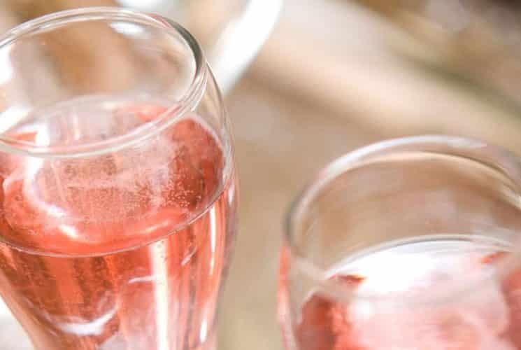 Two champagne glasses filled with pink rose